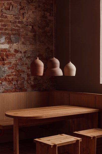 Ceramic lamps hanging over solid oak furniture