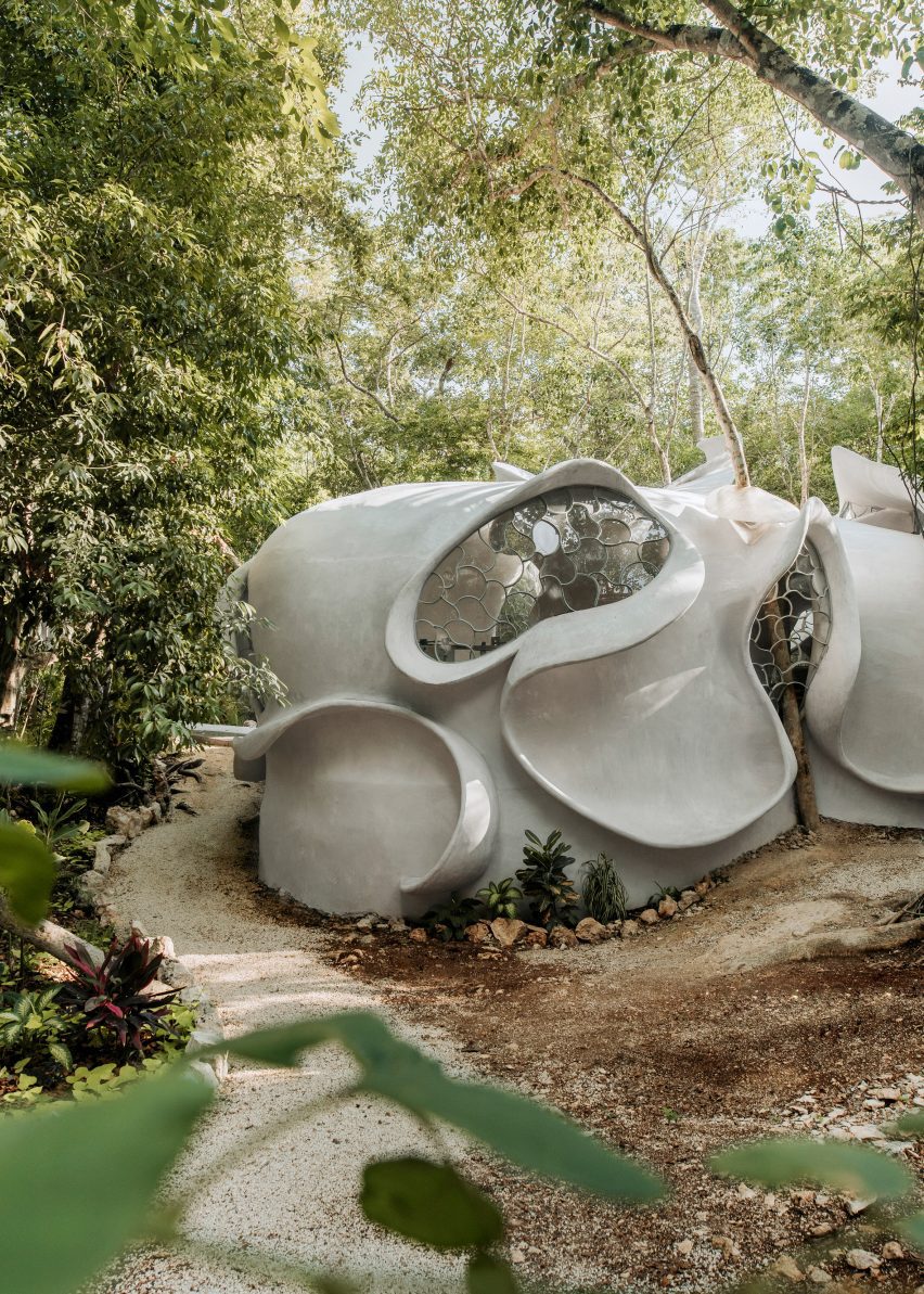 An amoeba shaped building with fins and a skylight