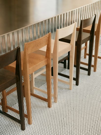 Bar counter and stools in restaurant in Geneva by Sapid Studio
