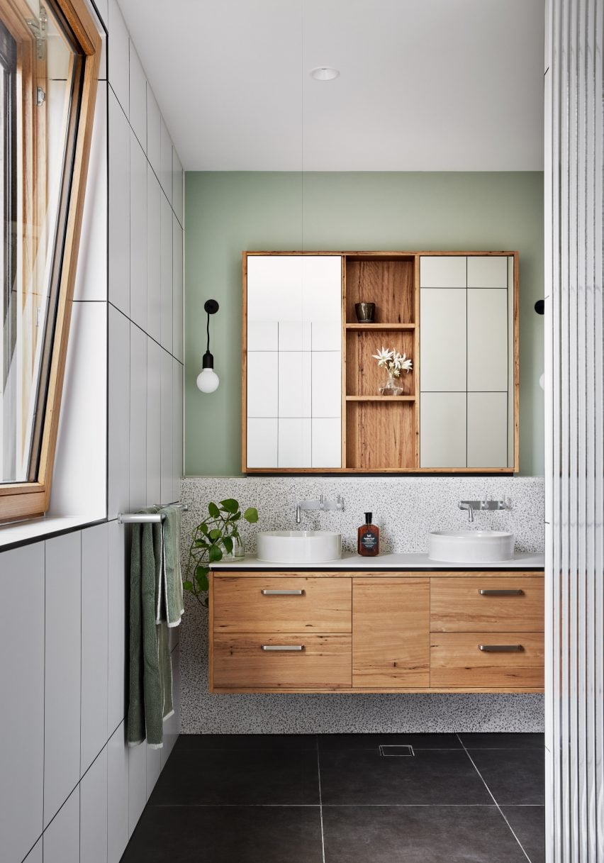 White-tiled bathroom with a wooden floating vanity unit