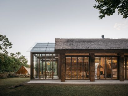 Thatched building with a glass extension