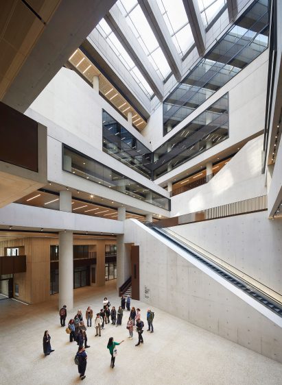 Atrium inside a concrete building by Stanton Wiliams