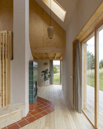 Plywood-lined living room with tiled fireplace