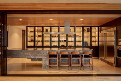 Wood-lined kitchen with a stone island