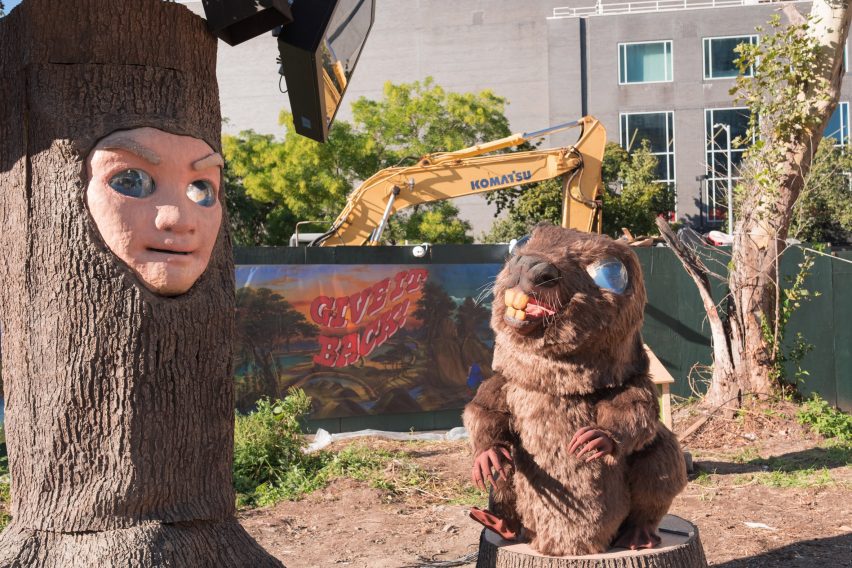 A large animatronic beaver and tree