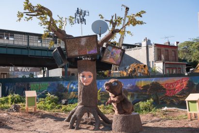 A large animatronic beaver and tree