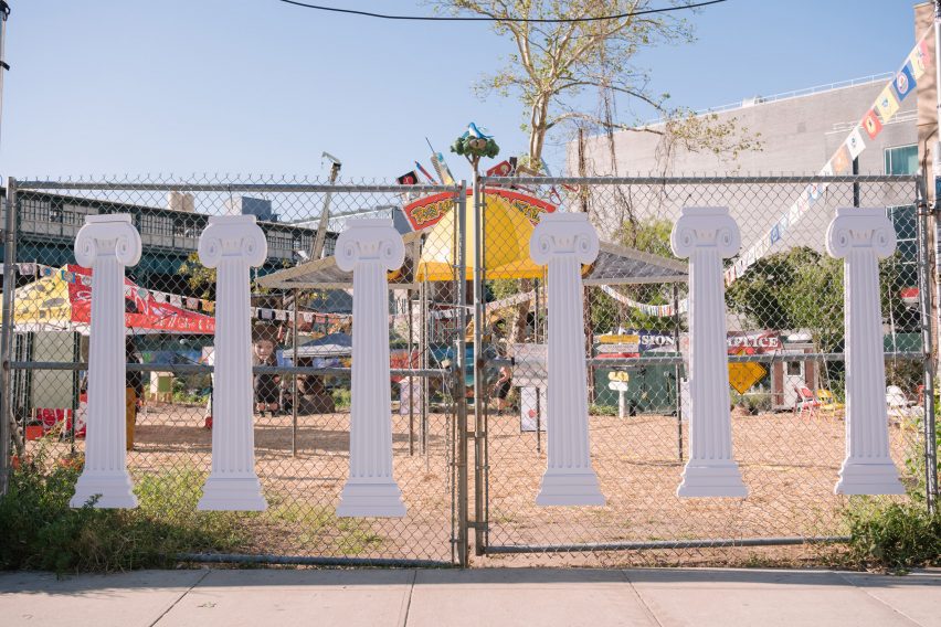 A fence with cut out columns affixed to it