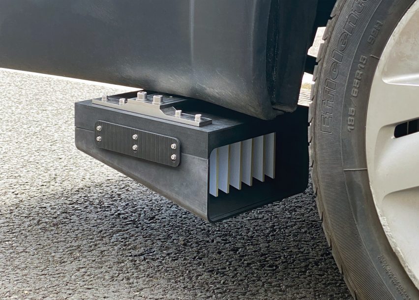 Photo of a box-like device mounted behind a wheel on a vehicle
