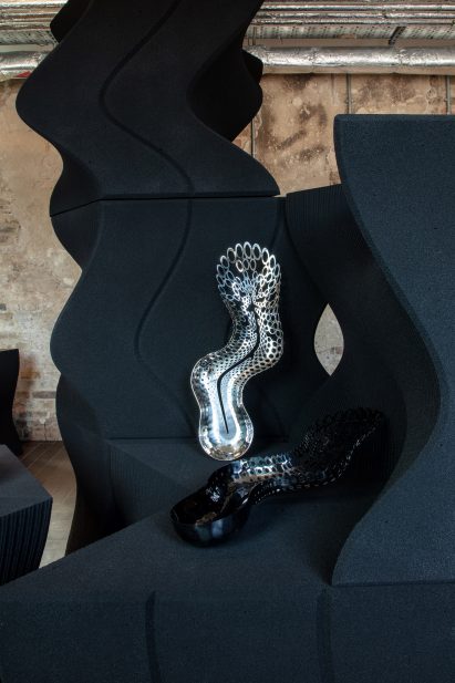 Undulating black display shelves