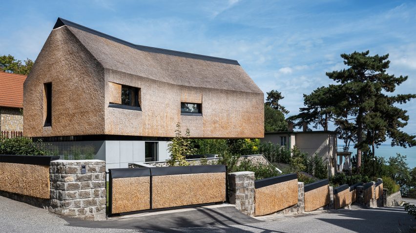 RAPA Architects' thatch roof, cantilevered holiday home in Hungary