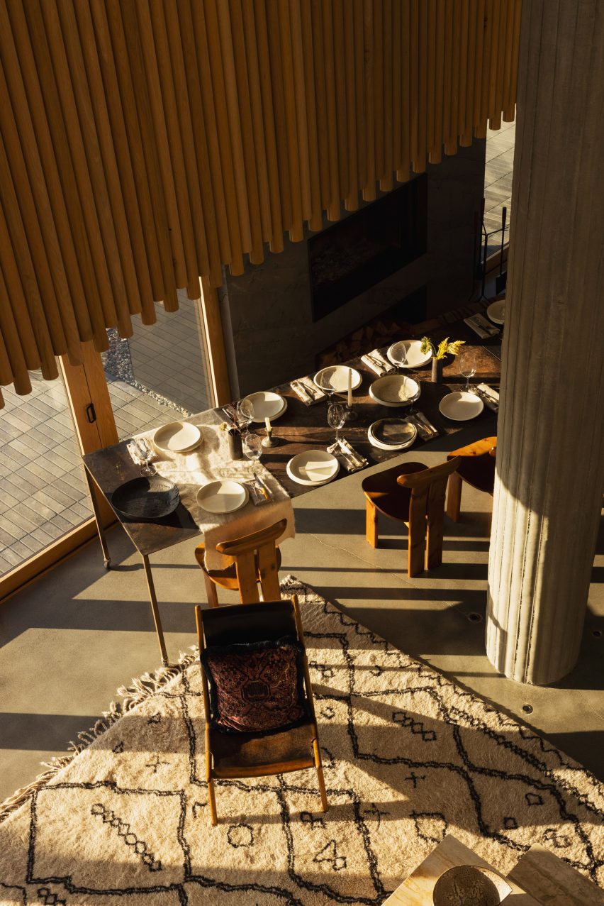 Looking down at dining room table set with dishes
