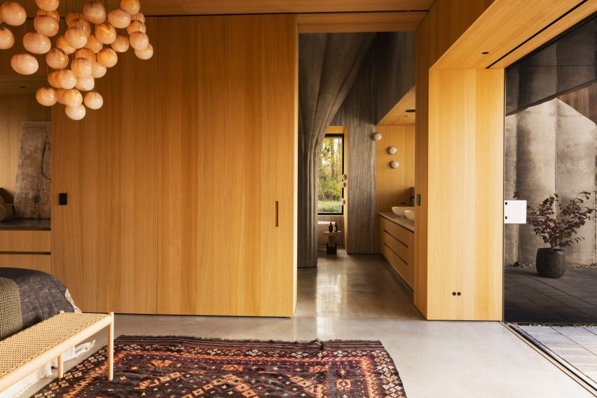 Bedroom with wooden walls and concrete floor