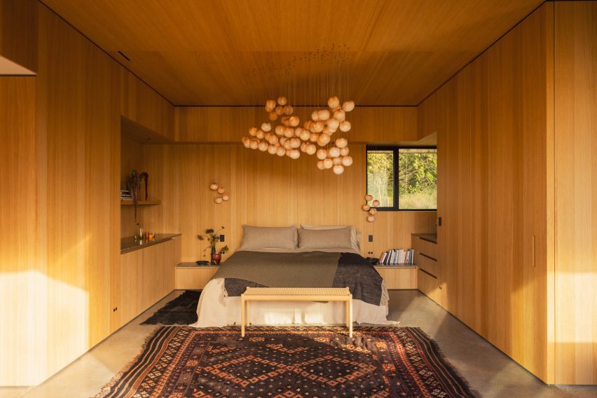 A bedroom with wooden walls