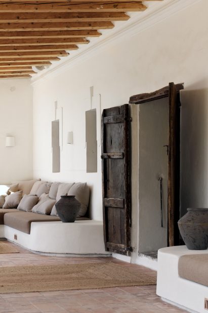 Covered porch with built-in seating and old wooden door