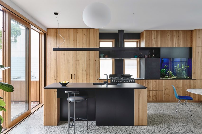Kitchen and living area with fish tank and doors to outside in Helvetia house Fitzroy