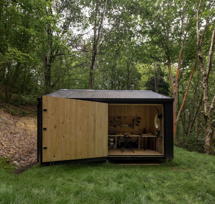 Aralar Cottage with a large timber door by BABELStudio