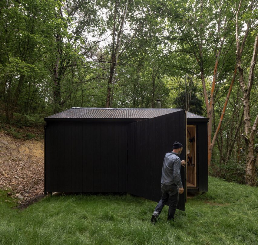 Aralar Cottage with a large timber door by BABELStudio