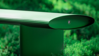 Bello! bench by Lars Beller Fjetland in the new forest green colour situated in a forest