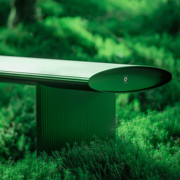 Bello! bench by Lars Beller Fjetland in the new forest green colour situated in a forest