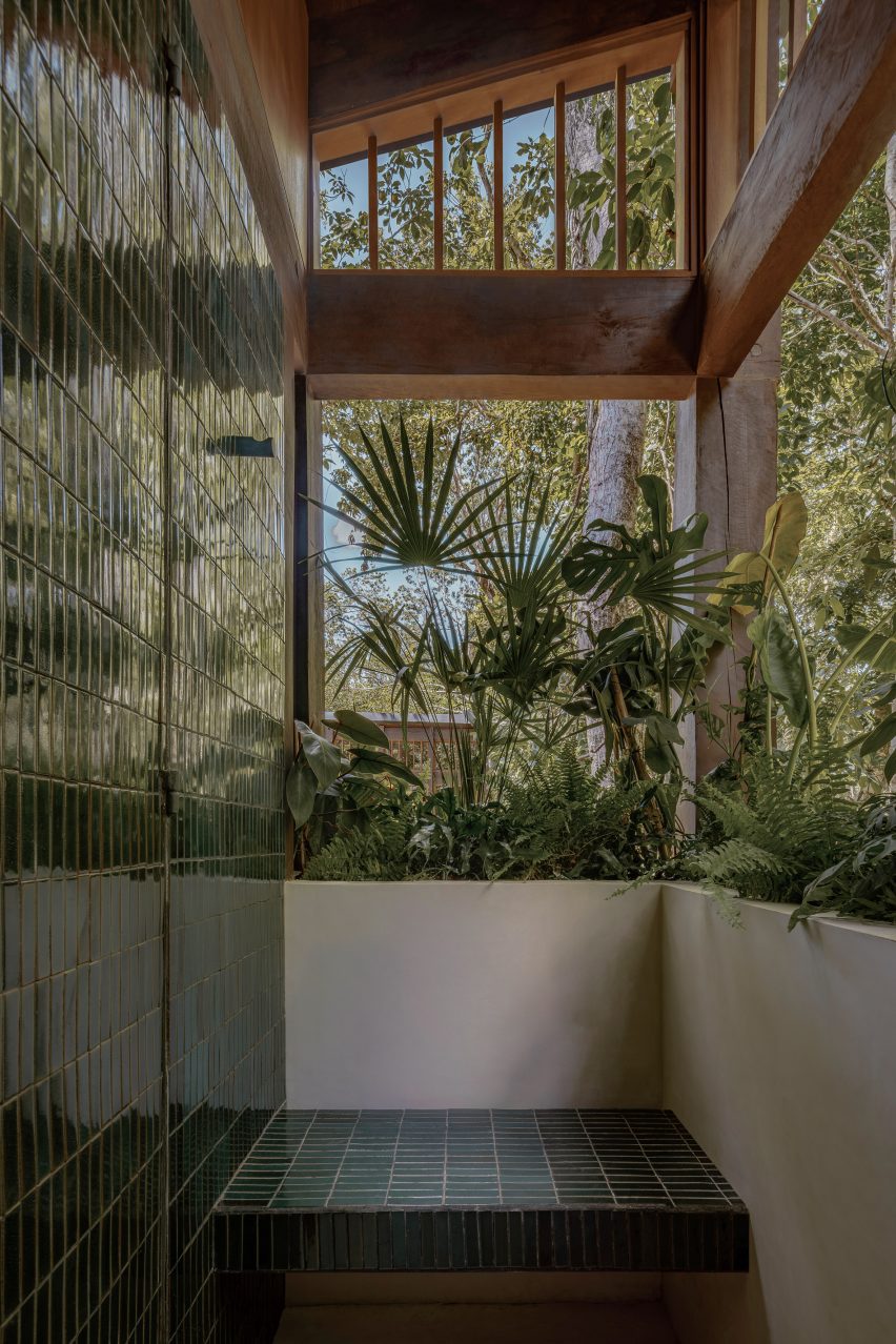 An open air bathroom with jungle plants