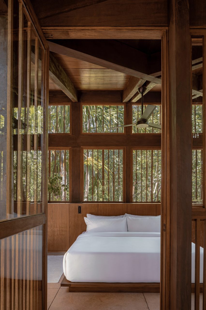 A crisp white bed in a treehouse hotel