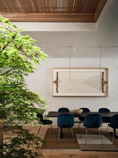 A dining room with brick wall painted in white