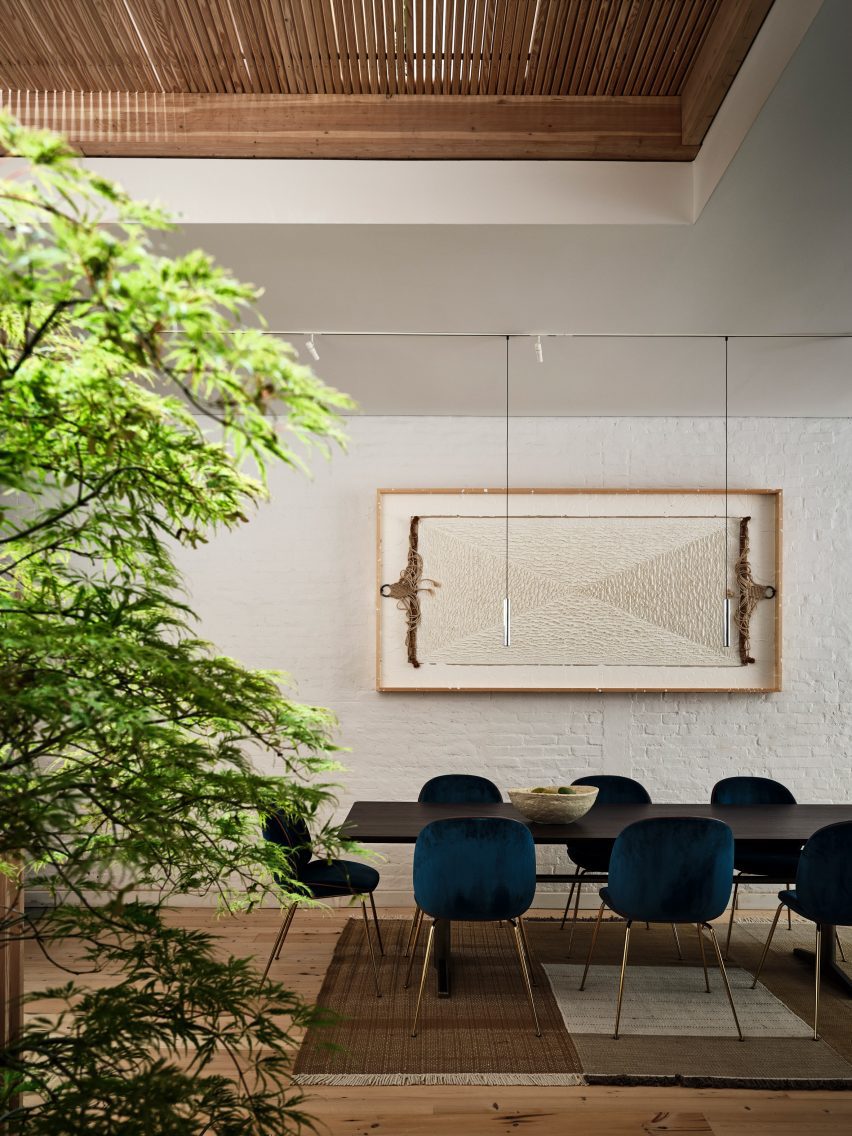 A dining room with brick wall painted in white