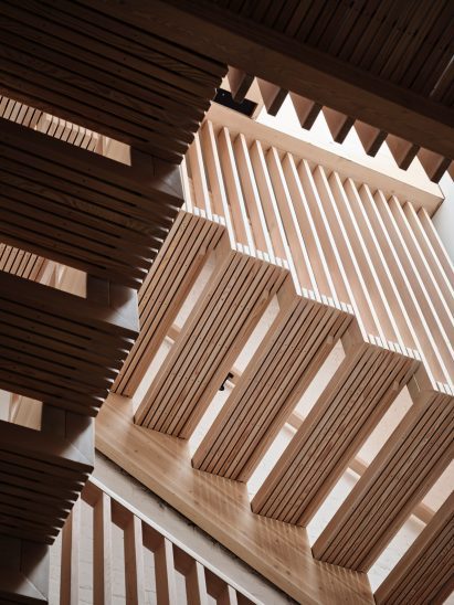 A wooden staircase made of slated treads and railing