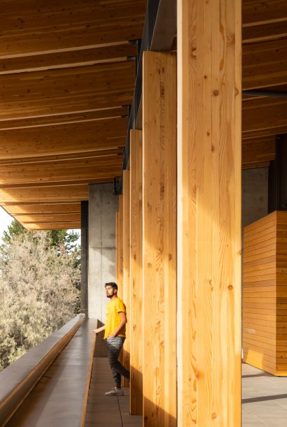 A person looking out over a balconyd