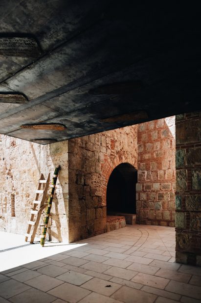 Arched tunnel within historic brick and stone