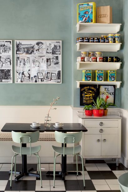 Pale green-grey plaster above wood wainscoting in the cafe