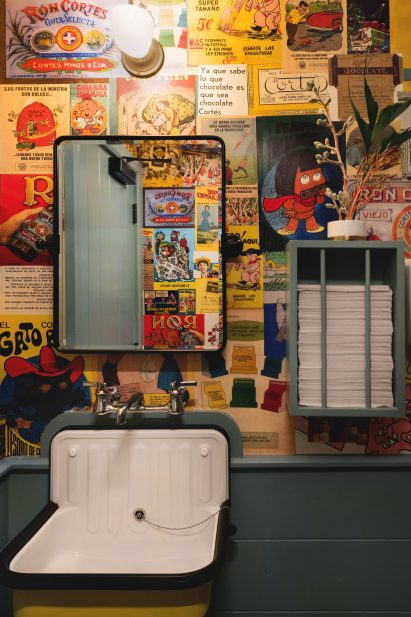 Bathroom is cartoon collage lining the walls