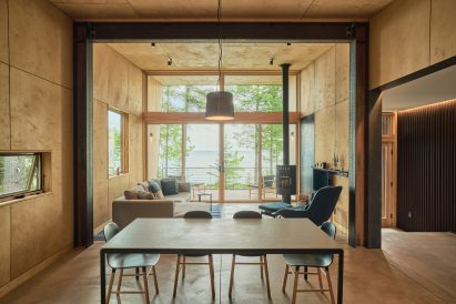 A modern cabin looking out over a lake