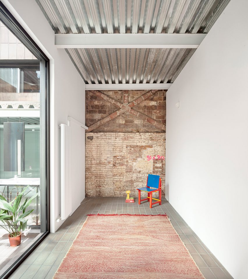 Remodelled Barcelona apartment with a metal ceiling and brick accent wall