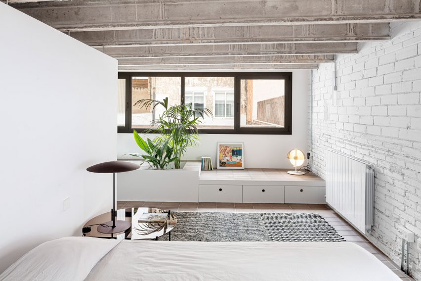 Bedroom with white walls and exposed ceiling beams