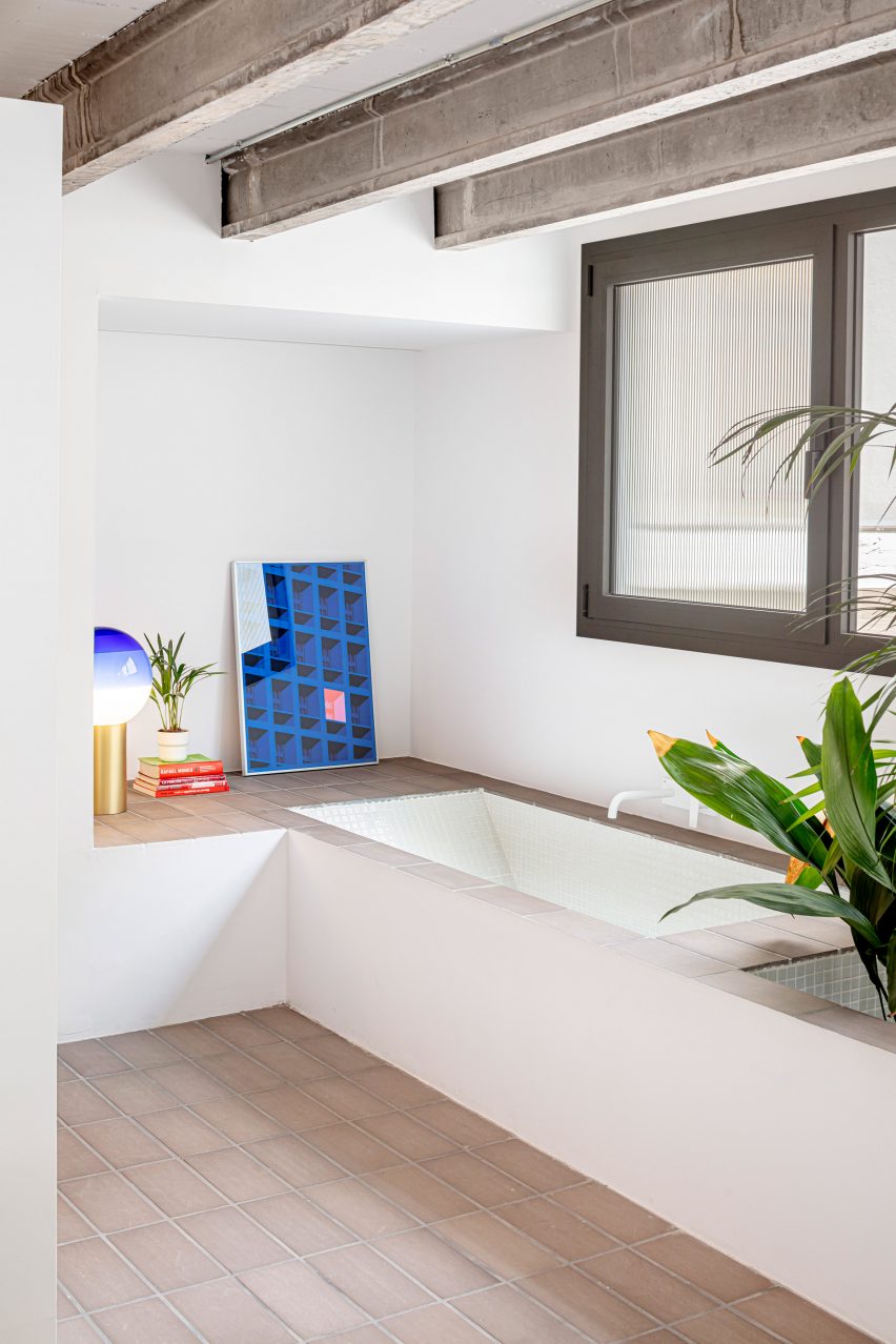 Bathroom with white walls and exposed ceiling beams