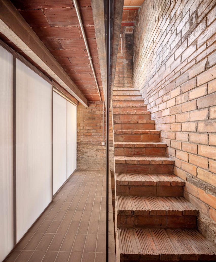 Brick staircase in a remodelled Barcelona apartment by CRÜ