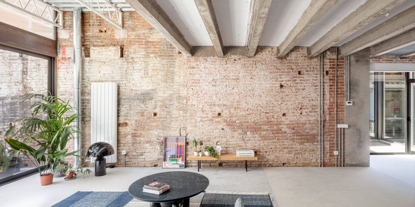 Living room with a brick wall and exposed ceiling beams