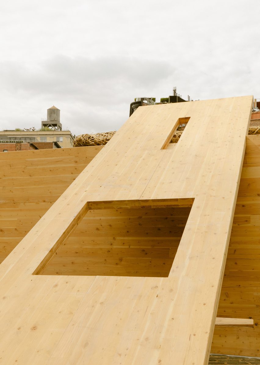 A CLT panel resting against another with square cut outs
