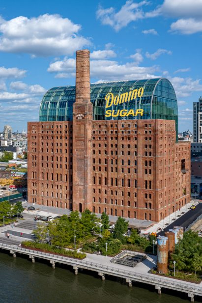 Building with historical brick facade wrapping new glass building