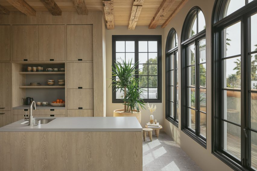 A large kitchen with light wood cabinetry
