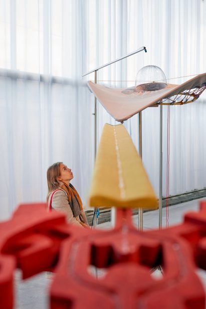 Woman looking up at water spraying onto a plastic dome