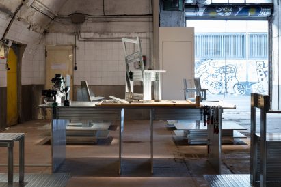 A workshop bench with a partially built chair on top