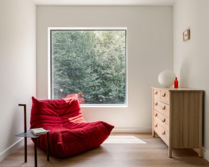A red togo chair in a living room