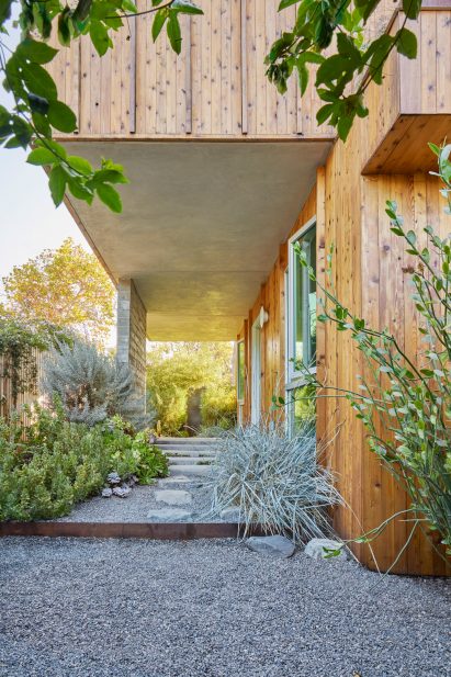 A wooden house with porch areea