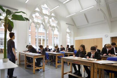 Classroom in a chapel with white walls and ornate windows