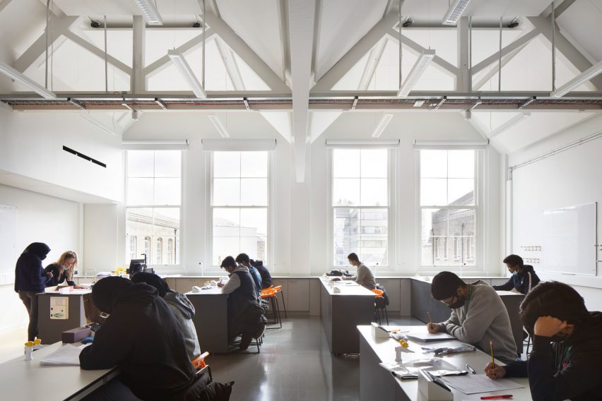 White classroom with pupils at grey desks
