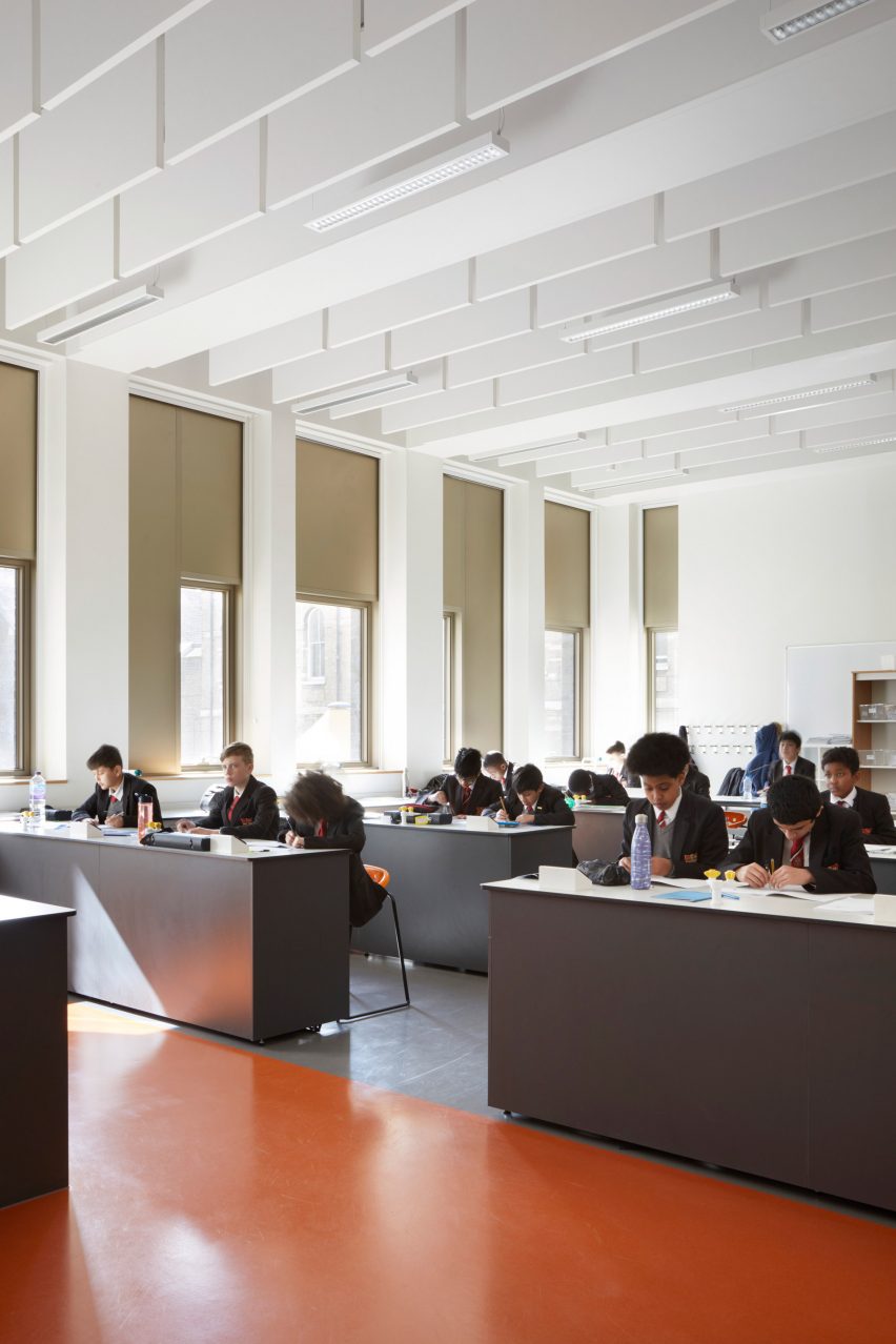 White classroom with pupils at grey desks