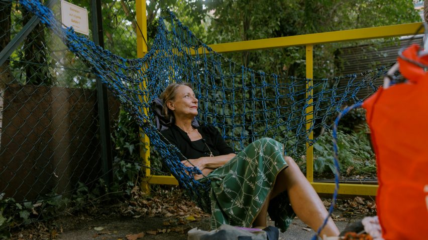 Woman sitting in Urban Networks hammock chair designed Membran for Vienna Design Week