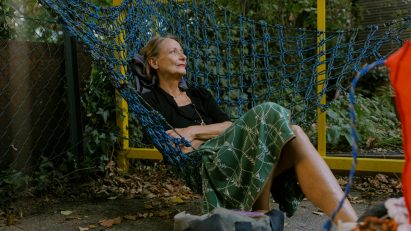 Woman sitting in Urban Networks hammock chair designed Membran for Vienna Design Week
